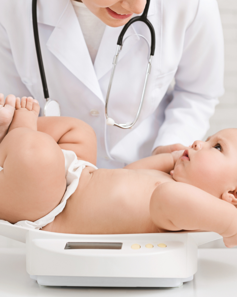 Doctor weighing a baby on a scale