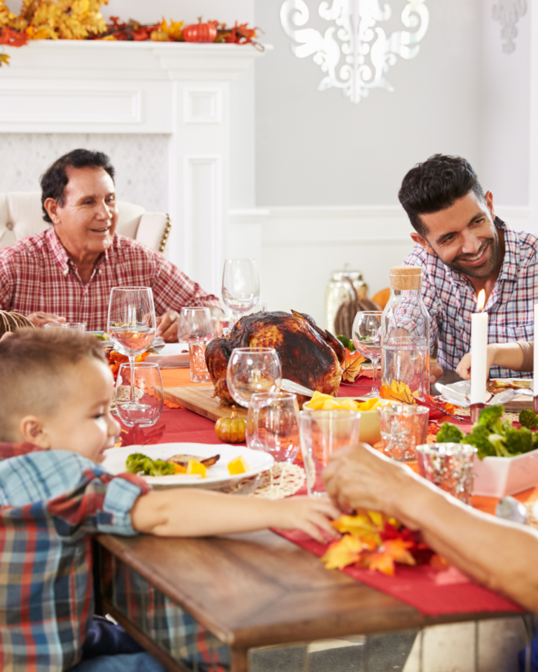 dad and grandpa at table with young toddler
