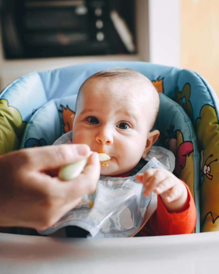 Feeding a baby in a high chair
